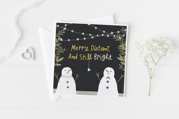 5x5 holiday card by Eliza Todd featuring two smiling snowmen, saying "Merry, distant and still bright." - APeaceofWerk.com